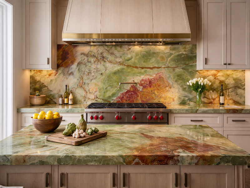 Luxury kitchen interior with Green Onyx countertops and feature wall
