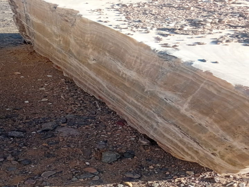 Raw Honey Onyx marble block ready for cutting and polishing