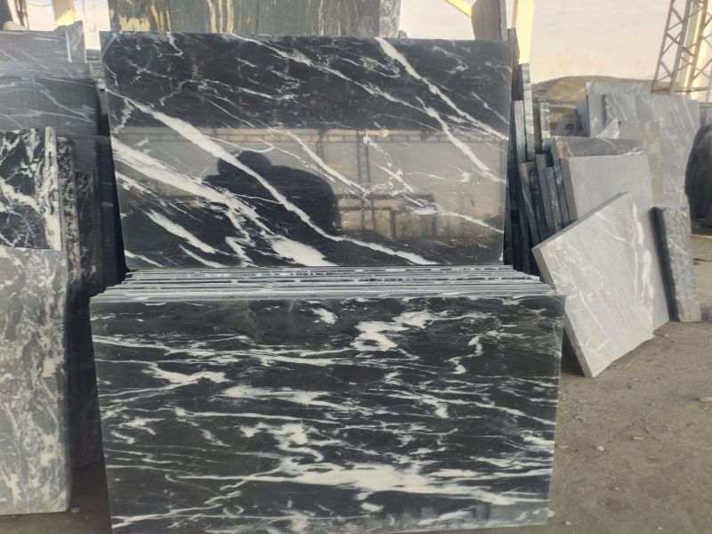 Polished black and white marble slab with natural stone texture and veining detail